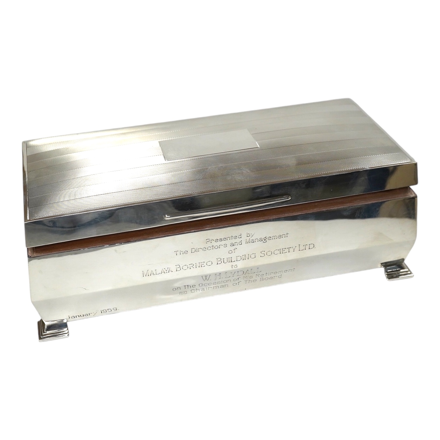 An Elizabeth II part engine turned silver mounted cigarette box, W.T. Toghill & Co, Birmingham, 1957, with engraved inscription, 26.4cm. Condition - fair to good